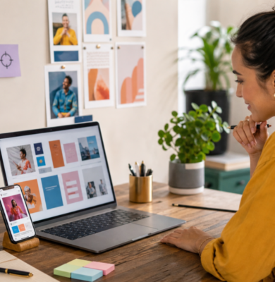 Small business owner reviewing Facebook and Instagram ad creative concepts on a laptop and phone.